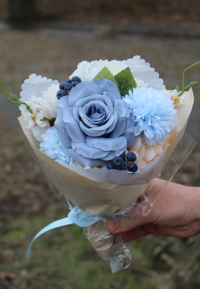 White, cream and orange coloured silk bouquet with mums, ranunculus, anemone, calla lilies and baby's breath. Bright coloured silk bouquet with roses, ranunculus, anemone, hibiscus and wisteria.