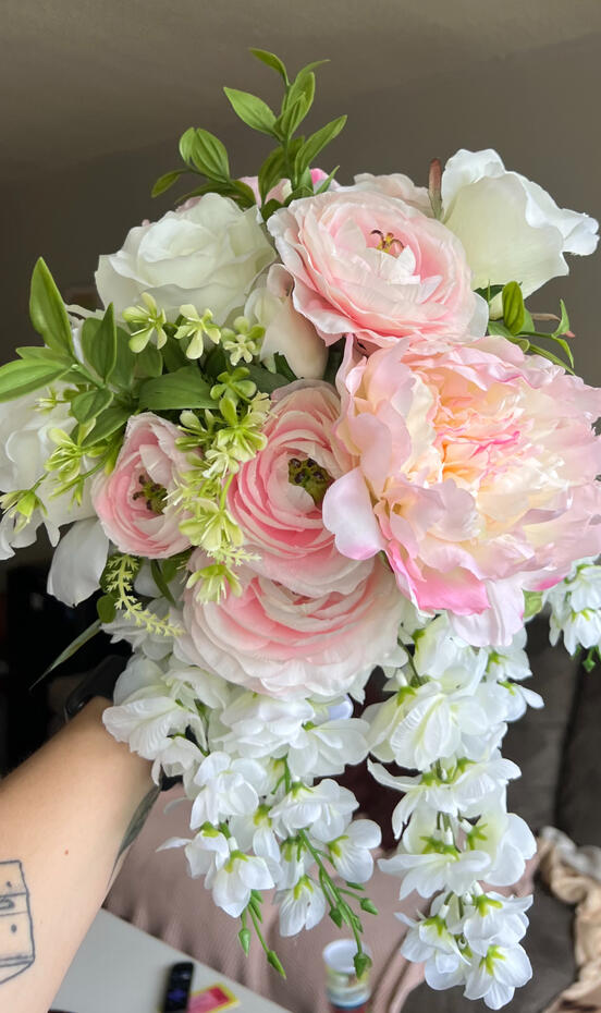 Pink and white silk bouquet with peonies, roses, ranunculus and wisteria. Pink and white silk bouquet with peonies, roses, ranunculus and wisteria.