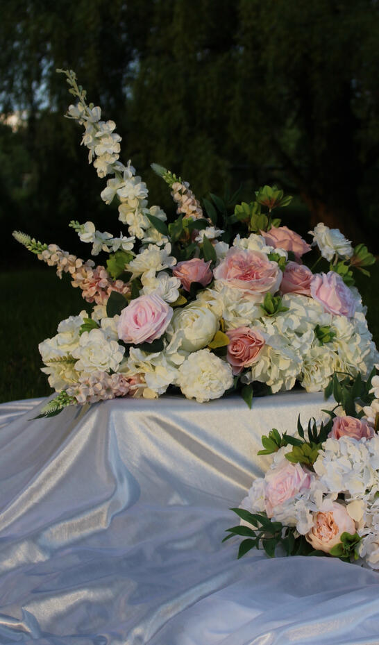 White silk bouquet with calla lilies, peonies, roses, and anemone. White silk bouquet with calla lilies, peonies, roses, and anemone.